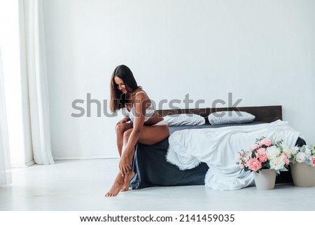 woman in linen in the bedroom on the bed