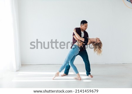 a man and a woman dance together a bachata dance Royalty-Free Stock Photo #2141459679
