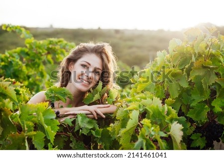 portrait of a woman in a vineyard of wine and juice