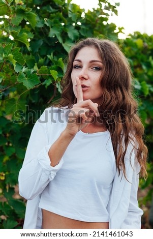 portrait of a woman in a vineyard of wine and juice