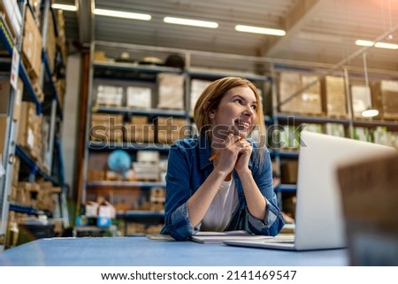 Woman using laptop at warehouse
 Royalty-Free Stock Photo #2141469547