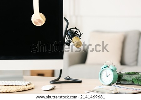 Modern workplace with microphone and computer in room