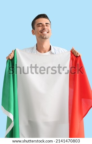 Young man with Italian flag on color background