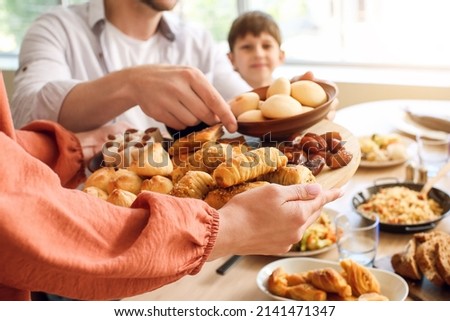 Muslim family having breakfast together. Celebration of Eid al-Fitr Royalty-Free Stock Photo #2141471347