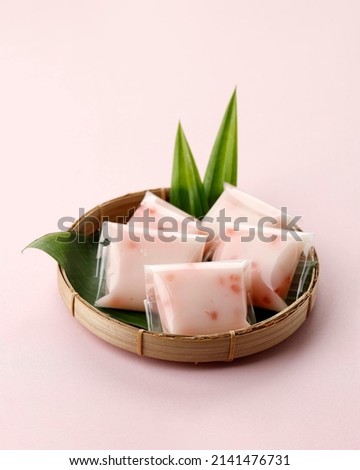 Cantik Manis or Jentik Manis (Kue Pacar Cina) , Cente is Indonesian Traditional Dessert made from Mung Bean Flour Hunkwe, Sago Pearl, and Coconut Milk. Served in bamboo Plate Royalty-Free Stock Photo #2141476731