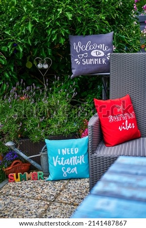 Summer scene with colorful decorations on a terrace in the garden.