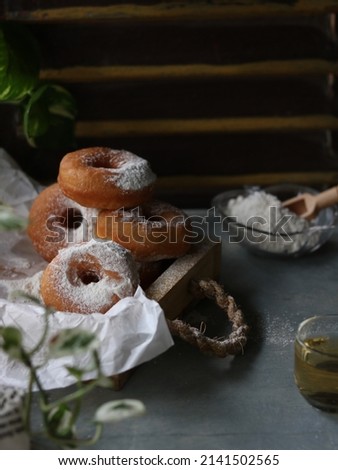 Donat kentang or Potato donuts with powdered sugar sprinkling, sweet and delicious, loved by children. Blurred, selective focus