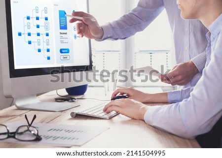 Document management system (DMS) allowing efficient business processes. colleagues working with file manager on computer screen at the office to approve a report. Digital transformation. Royalty-Free Stock Photo #2141504995