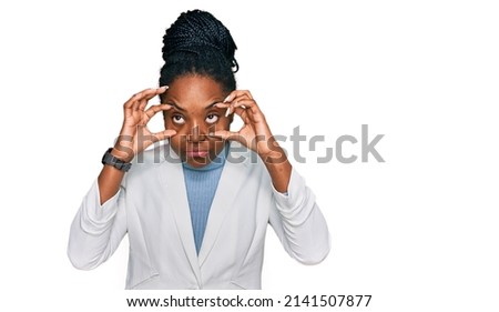 Young african american woman wearing business clothes trying to open eyes with fingers, sleepy and tired for morning fatigue 