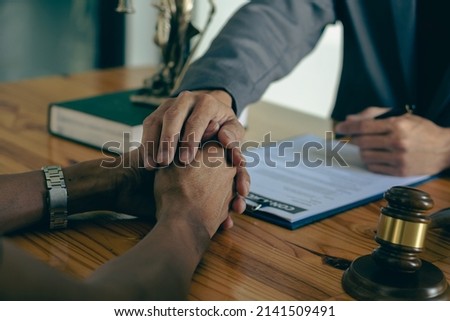 The client is explaining the offense to a lawyer and working together to resolve the offense. Concepts of litigation and justice in the Office of Legal Counsel to punish defendants in the courtroom. Royalty-Free Stock Photo #2141509491