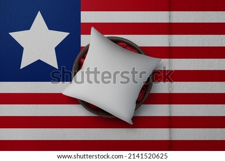 Patriotic pillow mock up on background in colors of national flag. Liberia