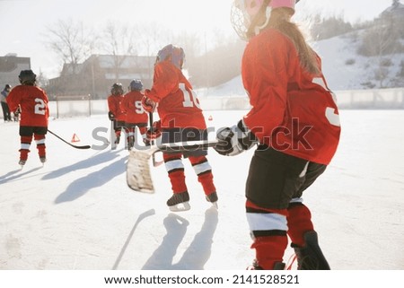 Ice hockey team skating on outdoor rink