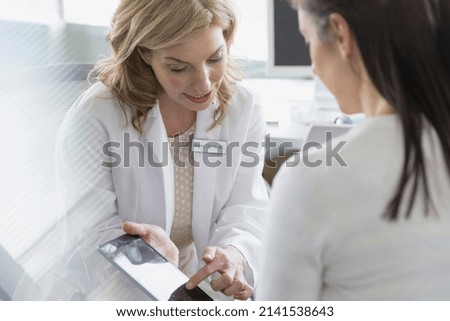 Doctor and patient looking at digital tablet