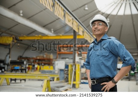 Confident worker in manufacturing plant