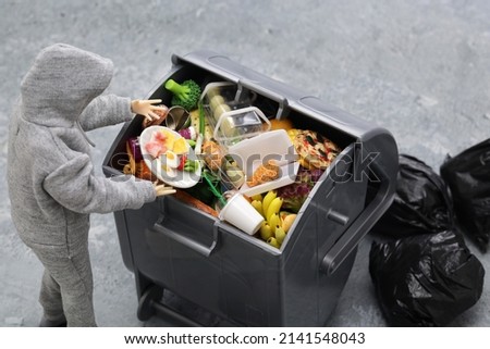 A trash can full of food that is still edible but thrown away (miniature photo) Royalty-Free Stock Photo #2141548043