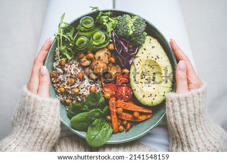 Woman holding plate with vegan or vegetarian food. Healthy plant based diet. Healthy dinner or lunch. Buddha bowl with fresh vegetables. Healthy eating Royalty-Free Stock Photo #2141548159