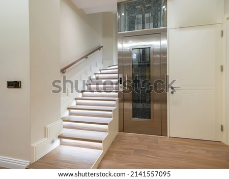 Stairs and elevator of luxury house Royalty-Free Stock Photo #2141557095