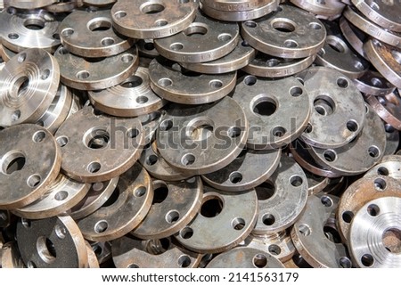 Set of steel flanges for pipeline equipment. Royalty-Free Stock Photo #2141563179