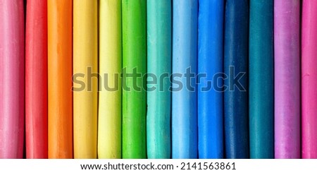 Row of colorful pastel crayons close up top view. New dry pastel. Artistic panoramic background for poster and banner design.