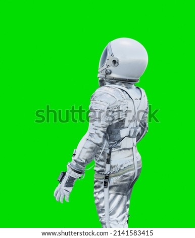 Astronaut isolated on a green background. perfect for compositing.