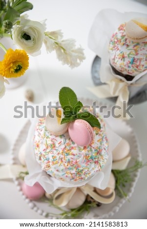 Lovely Easter composition, eggs, Easter cake on the table. Fresh flowers, bright morning in a wooden house.