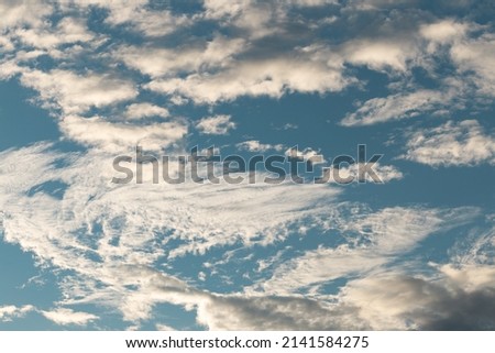 Feather clouds on the bright blue sky