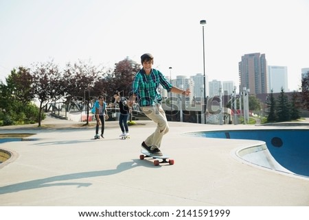 Teenage boys skateboarding at skateboard park