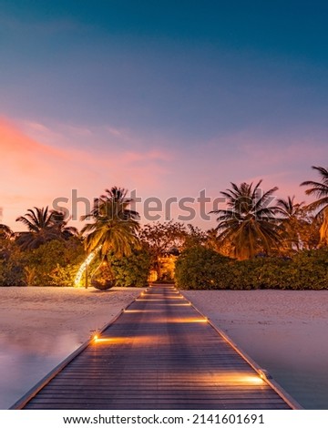 Amazing sunset panorama at Maldives. Luxury resort villas seascape with soft led lights under colorful sky. Beautiful twilight sky and colorful clouds. Beautiful beach background for vacation holiday Royalty-Free Stock Photo #2141601691