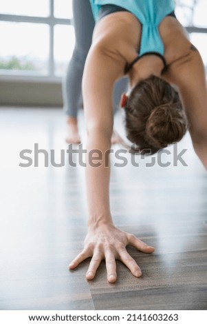 Woman practicing yoga in downward facing dog pose