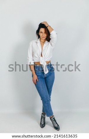 beautiful female model in a white shirt photo in the studio