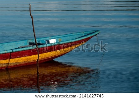 Close up of front side of small fisherman boat moored in port. small row boat floating 
