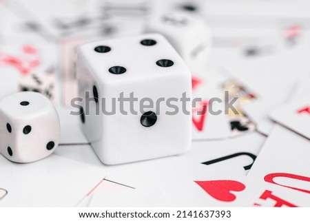 Beautiful picture of white dice cubes and solitaire cards. Perfect for commercial use and advertisements.