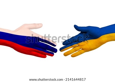 Handshake painted in the colors of the flags of Ukraine and Russia close up.