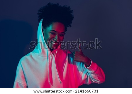 Photo of funky sweet woman wear sweatshirt hood showing thumb up isolated red color background