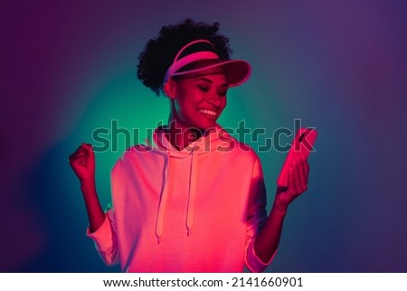 Portrait of beautiful trendy funky cheery girl using device smm app isolated over bright multicolor light gradient color background