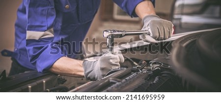 Car care maintenance and servicing, Close-up hand technician auto mechanic using the wrench to repairing change spare part car engine problem and car insurance service support. Royalty-Free Stock Photo #2141695959