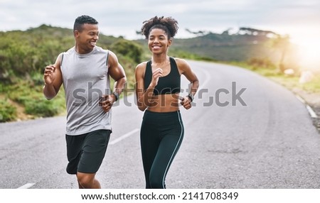 The healthier you are, the happier you feel. Shot of a sporty young couple exercising together outdoors. Royalty-Free Stock Photo #2141708349