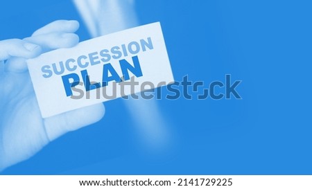 Succession Plan words on a card in hand of businessman. Business profit and success concept.