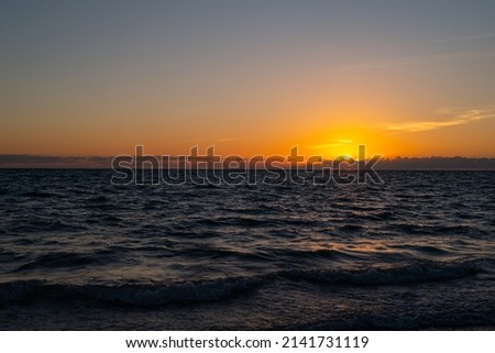 Sunset at sea landscape. Dramatic sunset sky with clouds. Dramatic sunset over the sea. Beautiful sunrise or sunset at sea.