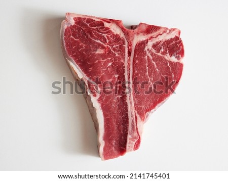 Top shot of delicious raw red beef meat placed on white background. Royalty-Free Stock Photo #2141745401