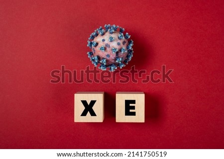 coronavirus and XE variant on a red background Royalty-Free Stock Photo #2141750519