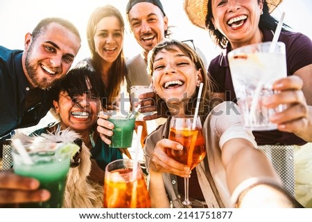 Happy different aged people taking selfie photo holding cocktail glasses outside - Cheerful family having fun together on summer vacation - Summertime lifestyle and happy hour concept Royalty-Free Stock Photo #2141751877