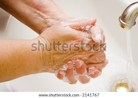 woman washing hand under running water white sink chrome spout Royalty-Free Stock Photo #2141767