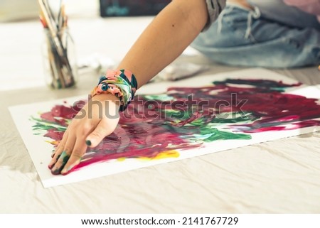 Abstract art. Modern Artist paints on the canvas with his hands. CloseUp. High quality photo