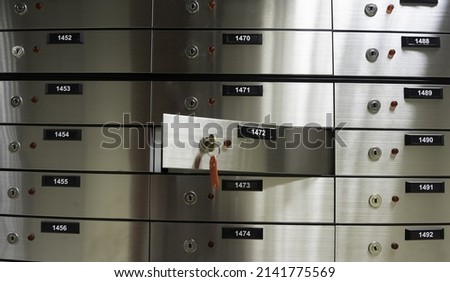 Safe deposit boxes inside bank vault. Open deposit box with key Royalty-Free Stock Photo #2141775569
