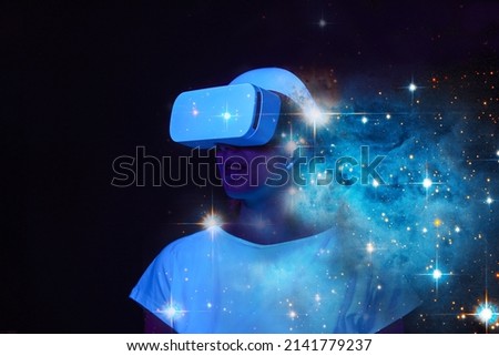 Woman is using virtual reality headset. Elements of this image furnished by NASA.