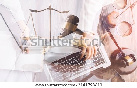 Male lawyer working with contract papers and wooden gavel on tabel in courtroom. justice and law ,attorney, court judge, concept. Royalty-Free Stock Photo #2141793619
