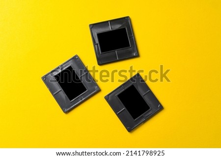 Photography empty slide frames on yellow background, top view