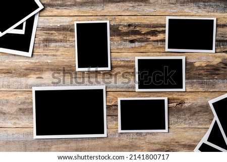 Blank photo frames for your photos on wooden background, copy space
