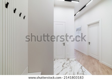 interior of a new corridor with white doors and white floor